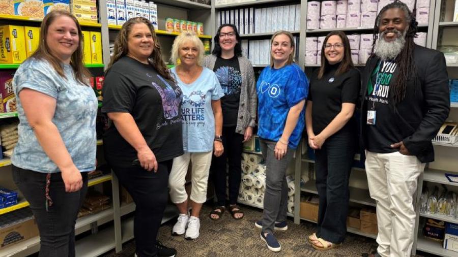 The Counseling and Community Care Hub staff is pictured in the food pantry in the Gordon Student Center.