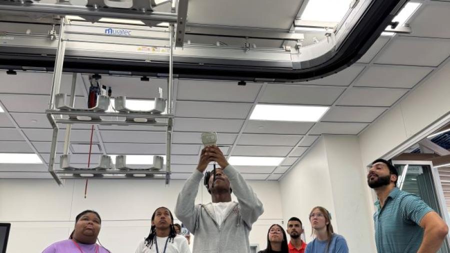Students in the Pre-College Semiconductor Summer Program experiment with the robotics in the new Micron Cleanroom Simulation Lab on the Onondaga Community College campus.