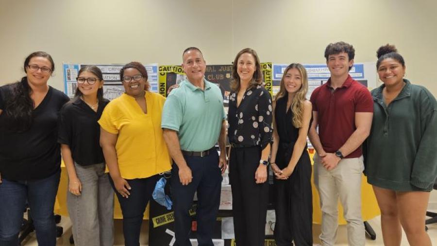 Students in the Criminal Justice Club welcomed Esteban Gonzalez (center left) and Julie Corn (center right) of Onondaga County's 911 Center to campus for their first meeting of the year.