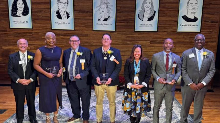Left to right: event emcee Glenn LaPoint '16, Chidera Joseph '16, Rob Kent '82, Brandon Lazore '14, Heather Silvia '90, Quindell Williams '08, OCC President Dr. Warren Hilton.