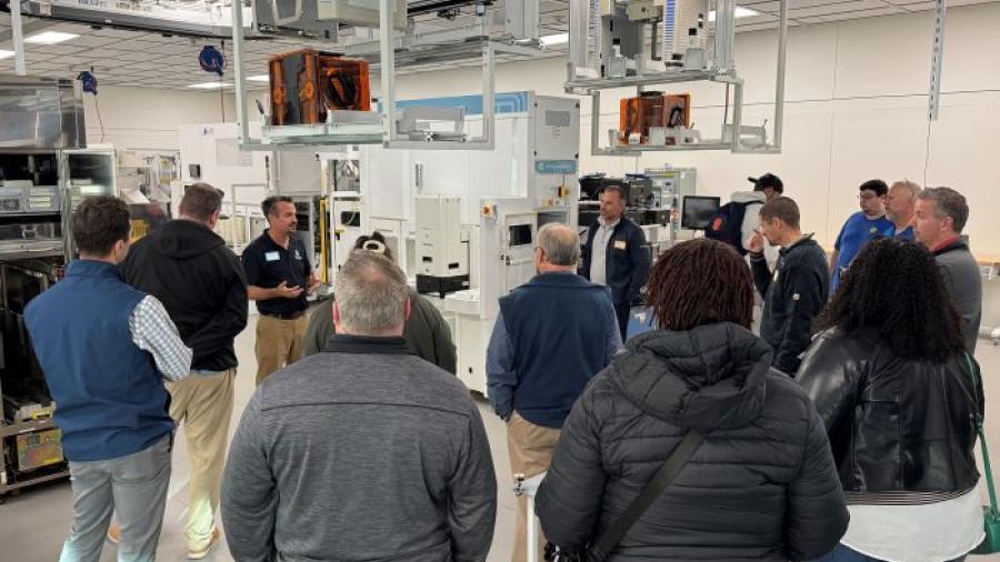 Professor Mike Grieb speaks with industry partners in the Micron Cleanroom Simulation Lab on the Onondaga Community College campus.