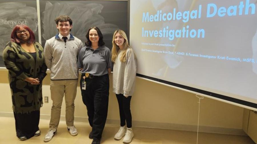 Criminal Justice Club Officers pictured with Taylor Bourdan (dark gray shirt) of the Onondaga County medical Examiner's Office are (left to right) Dionnarae Jones, Aidan Mott, and Harley DeOrdio.