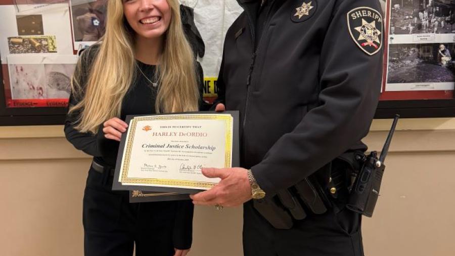 Haley DeOrdio is presented the New York Sheriff's Scholarship by Onondaga County Sheriff Toby Shelley. They are pictured in Ferrante Hall on the Onondaga Community College campus.