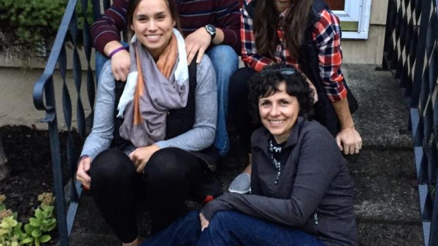 Dee DiCocco (seated on bottom step) is pictured with her three children who all earned degrees at Onondaga Community College - Maria (seated next to her), Jeff, and Carly (next to Jeff).