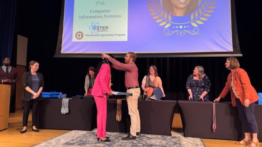 Graduating student Gleisis Salazar Del Rio receives her Educational Opportunity Program cord from Student Navigator Hunter Overstreet during the opportunity program's graduation celebration.