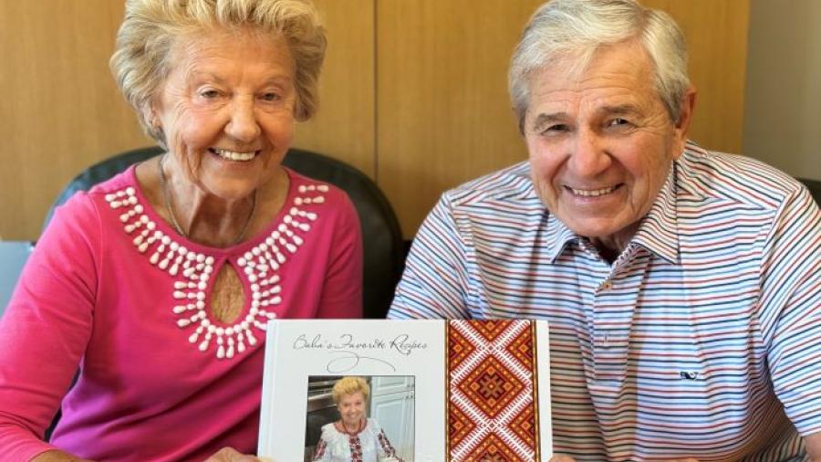 Alumna Halyna Lisnyczyk '65 (left) and her husband and Professor Emeritus Victor Lisnyczyk (right) are pictures with their cookbook, which has raised more than $45,000 for an orphanage in Ukraine.