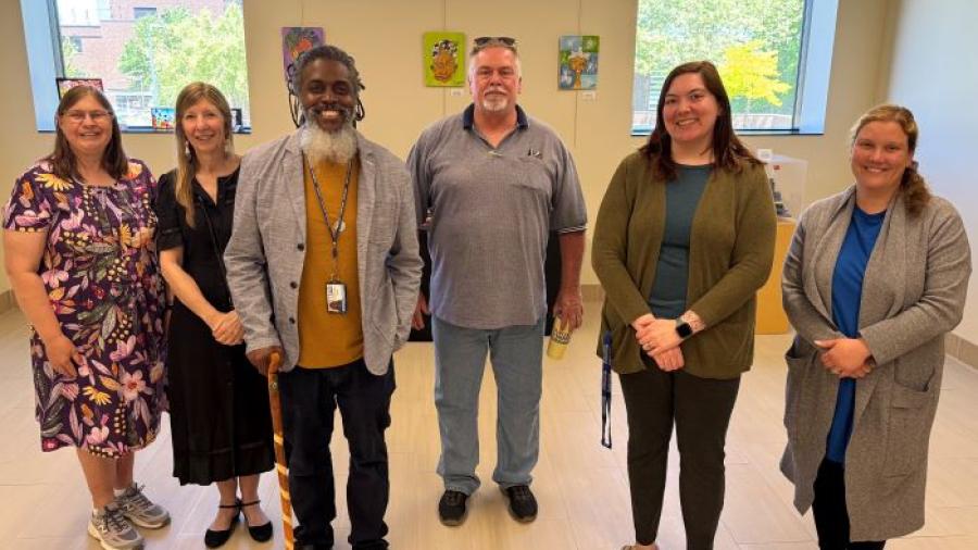 Onondaga Community College faculty and staff gathered for a reception celebrating their "On My Own Time" art exhibit.