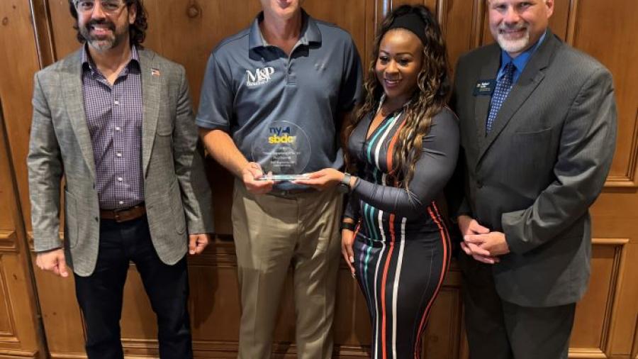 Paul Olszewski receives the Veteran Entrepreneur of the Year Award from New York SBDC State Director Sonya Smith. Also pictured are Dan Rickman of the SBA (left) and Bob Griffin of the North Central SBDC (right).