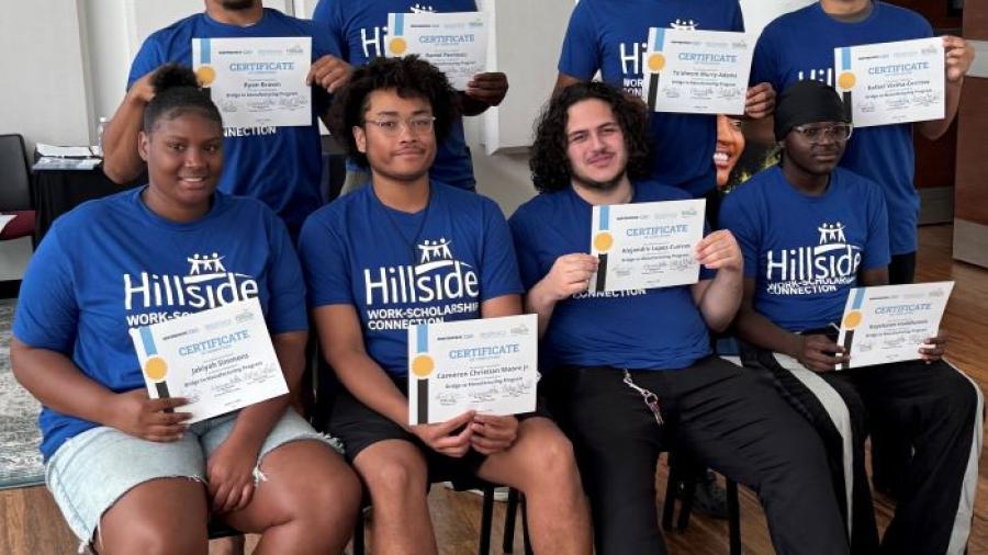 The first group of Syracuse City School District students to graduate from the Bridge to Manufacturing Learning Community program proudly pose for a group photo.