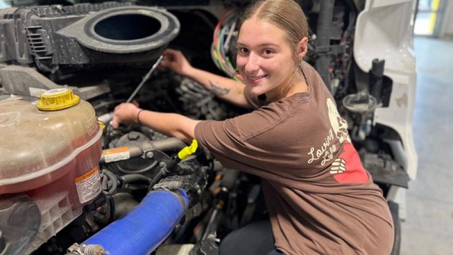 Alaina Kelsey is one of the top students in Onondaga Community College's Automotive Technology and Commercial/Heavy Equipment Service Repair degree programs. She's pictured working on a 2023 Freightliner in the College's new Commercial/Heavy Equipment Service Repair garage.