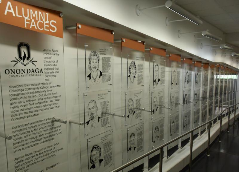 Photo of Alumni Faces etchings in the halls of the Academic II building.