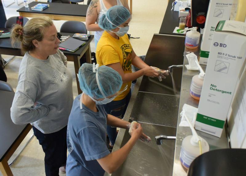 Photo of students washing their hands in Surgical Technology class