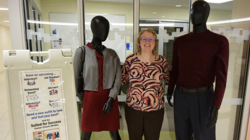 Abbey Baird is Director of OCC's Career Services Office. She's pictured in Coulter Hall with mannequins whose clothes are changed regularly to show students different ways to dress for success.