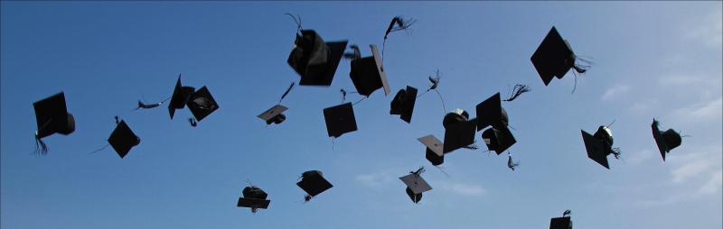 Graduation caps thrown into the air