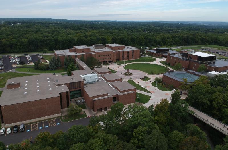 Aerial Shot of OCc's West Campus which includes three brown building and a clock tower