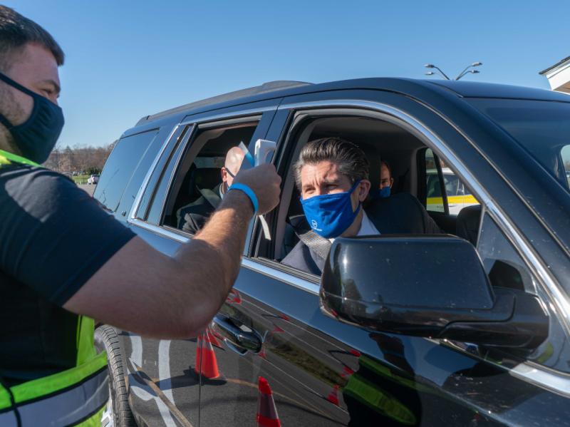 SUNY Chancellor Dr. Jim Malatras has his temperature taken as he enters the Onondaga Community College campus.