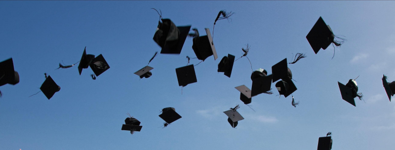 Graduation caps in the air