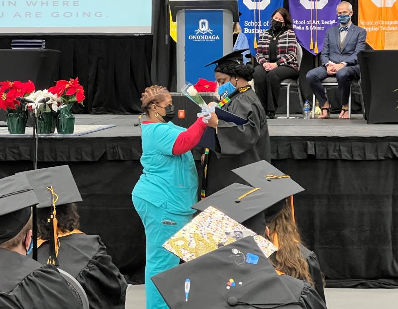 Mom pics daughter during Nurse Pinning Ceremony