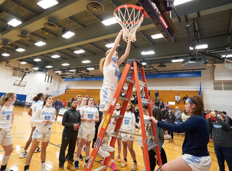 OCC's Hannah Durand cuts down the nets following the Women's Basketball teams Region 3 Championship. Both the Women's and Men's Basketball teams will play for national championships next week.