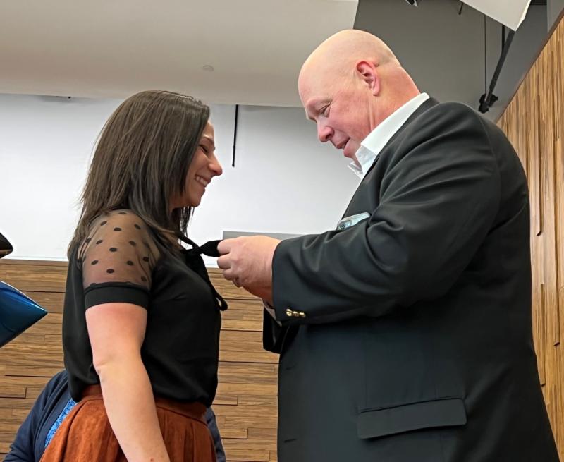 Brett VanSlyke (right), a 2012 graduate of OCC's Nursing program and a nurse at St. Joseph's Hospital, pinned his daughter Rachel during the ceremony.