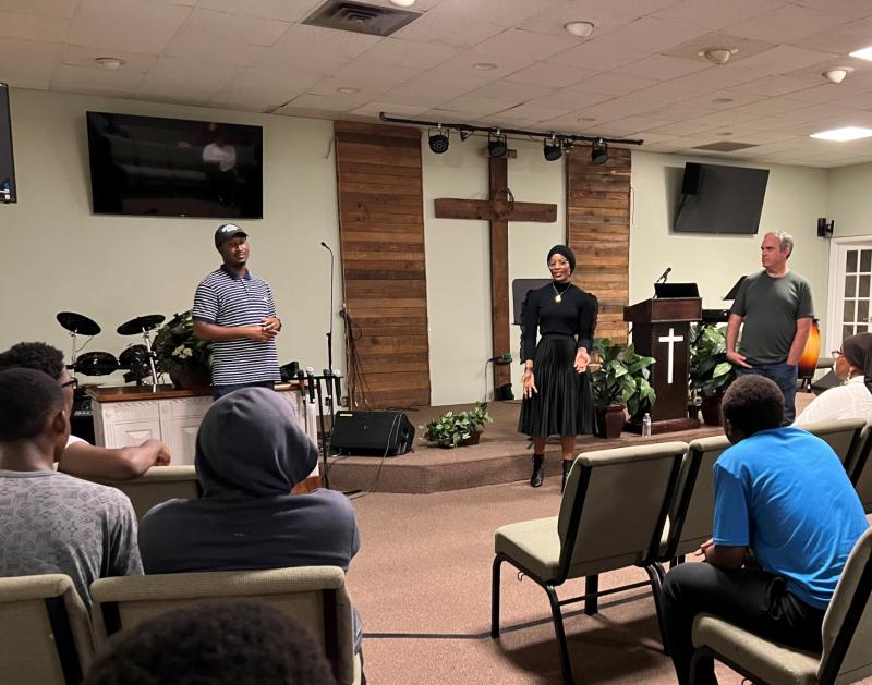 Speaking with students in the Refugee and Immigrant Self-Empowerment Summer Education Program are (left to right) Mo Brown '17, Hassina Adams '17, and Professor Patrick Kenny.