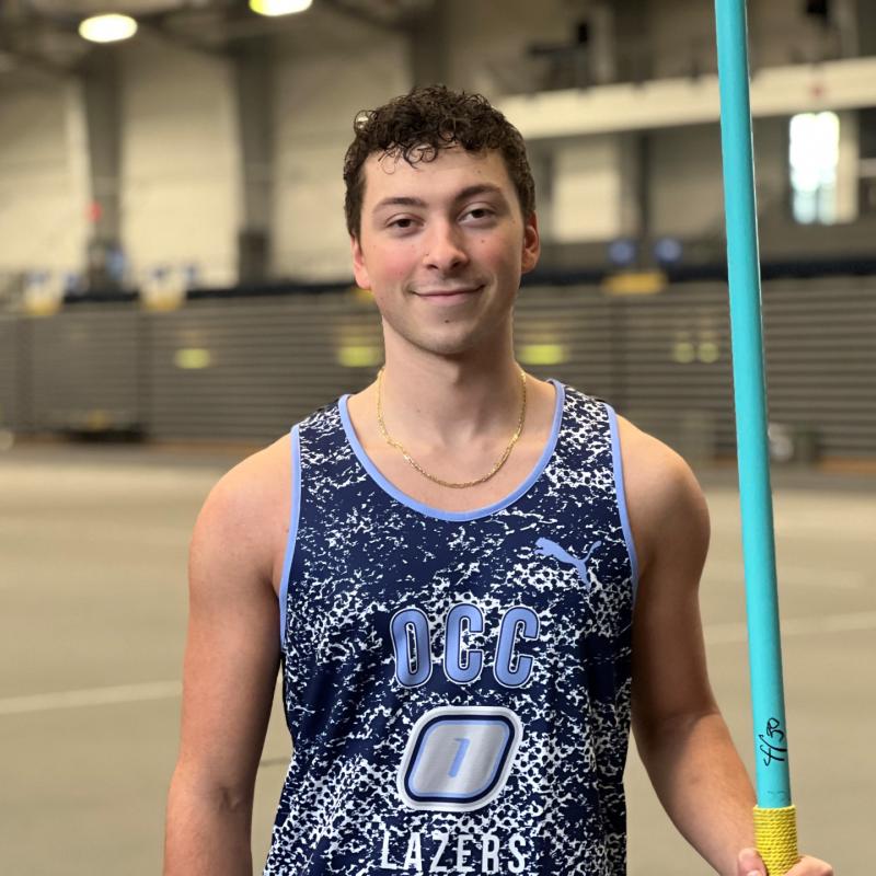 Andrew Coleman is a member of OCC's Track &amp; Field team and President of the Phi Theta Kappa Honor Society. He's pictured in the SRC Arena, holding a javelin which he uses in the decathlon event. Last year Coleman finished 4th in the nation in the decathlon.