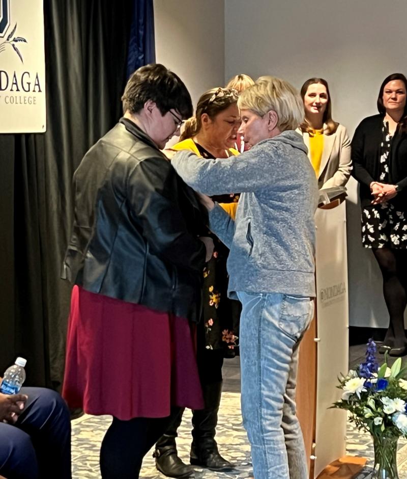 Gabriella Argiro (left) receives her Nursing pin from her grandmother Lynore Constantine (right) during the Nurse Pinning Ceremony December 14 in the Otis Suite.