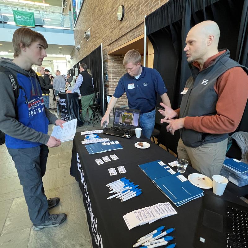 OCC student Nathan Moorehead (left) speaks with Jamie Barber (right) and Will Glass (center) of Schneider Packaging at the Career &amp; Applied Technology Career Showcase. The event was held March 28 in the Whitney Applied Technology Center.