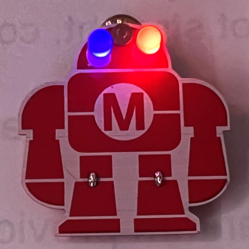 OCC's CSTEP students helped Maker Faire Syracuse attendees make these light-up robot pins, turning them into a &quot;must have&quot; item.