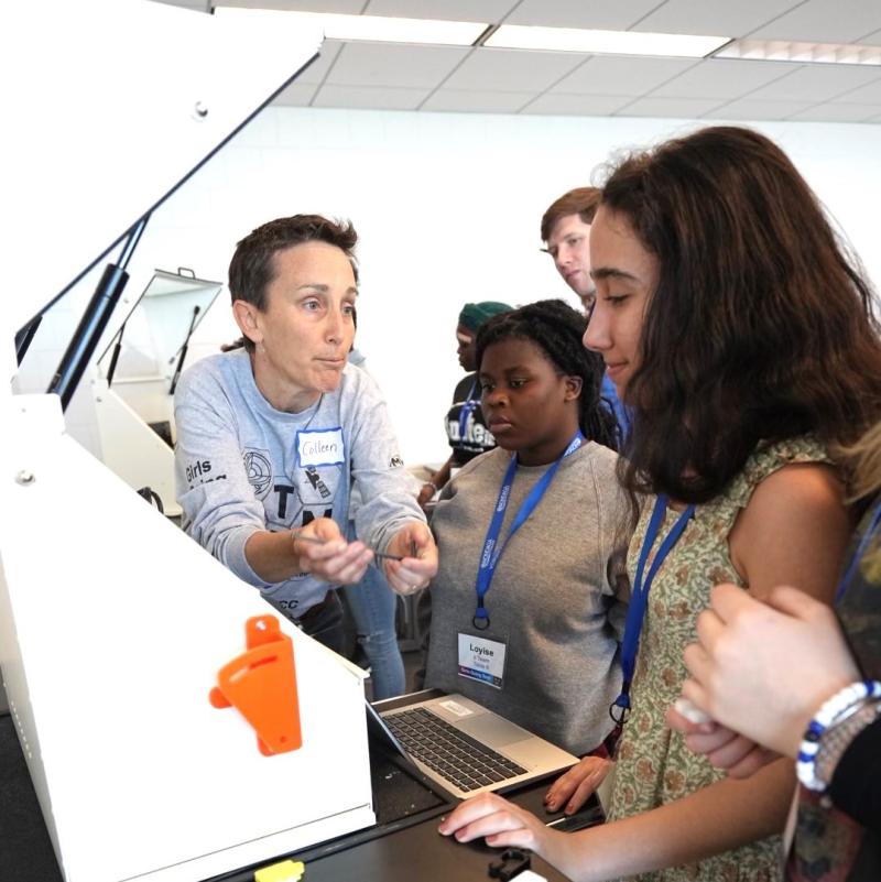 Colleen Stevens (left) works with students during a CNC Machining exercise as part of a Micron-Sponsored &quot;Girls Going Tech&quot; event at Onondaga Community College.