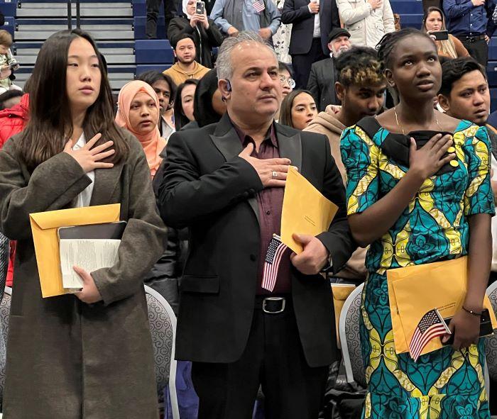 New American citizens recite the Pledge of Allegiance during a Naturalization ceremony held November 9 in the SRC Arena.