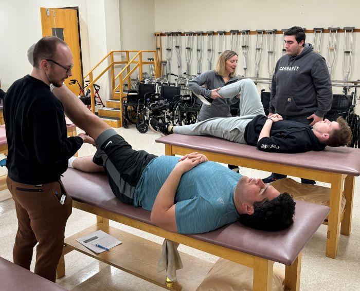 Professor Kristen Lounsbery PT, DPT, NSEd, ACCE works with students in the Physical Therapists Assistant lab in Ferrante Hall. Students who graduated from the program in 2023 achieved a 100% pass rate on the national exam which is well above the nationwide average.