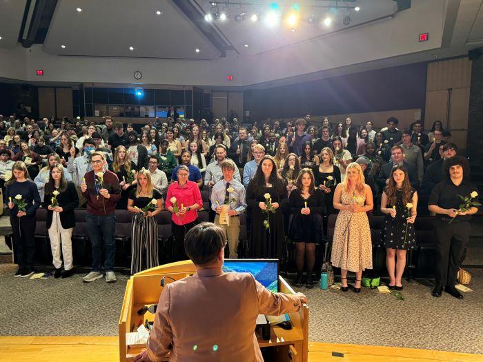 New Phi Theta Kappa Honor Society members are congratulated by Advisor Dr. Annie Tuttle (at podium with back to camera).