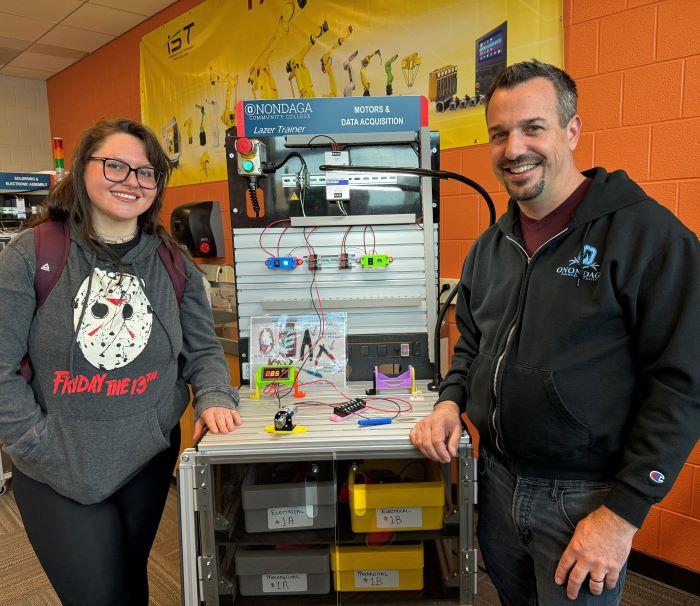 Bella Gutkin is in her first semester in OCC's new Electromechanical Technology certificate program. She's pictured with Applied Technology Professor Mike Grieb (right) in the Robotics Lab in the Whitney Applied Technology Center.