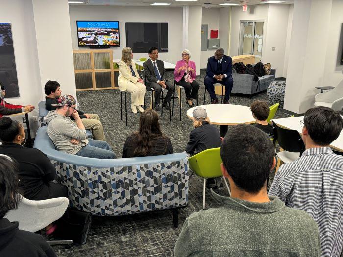 Dr. Arati Prabhakar (wearing pink blazer) speaks with students in the new Center for Teaching and Learning Innovation in Coulter Hall.