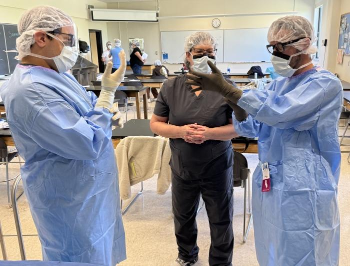 Professor Dorothy Dobrowolski (center) prepares students to work in an operating room in OCC's Surgical Technology degree program.