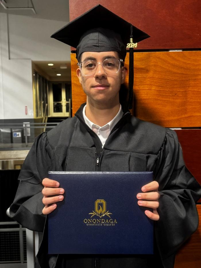 Kyrillos Dawoud is a graduate of Cicero-North Syracuse High School who is completing his Business Administration degree a semester early. He immigrated to the U.S. from Egypt 16 years ago. Both of his parents are also OCC graduates. He's pictured following OCC's Graduation Ceremony Wednesday night.