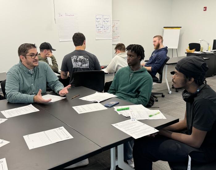 Professor Johnathon Sly (left) works with students in his ELM 100 (Electromechanical Technology) class during the fall 2024 semester..