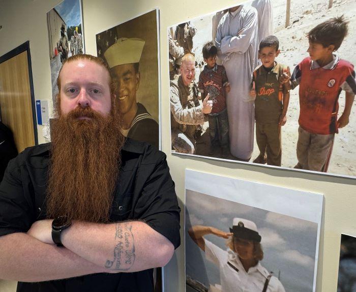 Jacob Blackwelder is pictured next to a photo of himself, teaching Iraqi children how to make a &quot;thumbs up&quot; sign. Blackwelder served 5 years in the Marines and is a student at OCC.