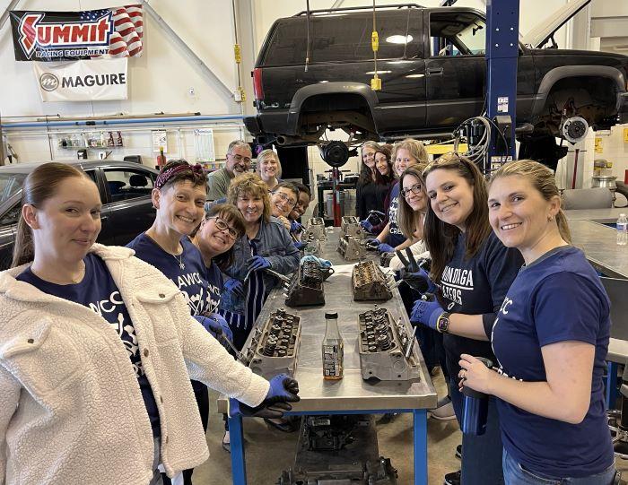 OCC's AAWCC chapter members learn how to replace sparkplugs during their &quot;Ask The Mechanic&quot; event in the Automotive Technology lab on campus.