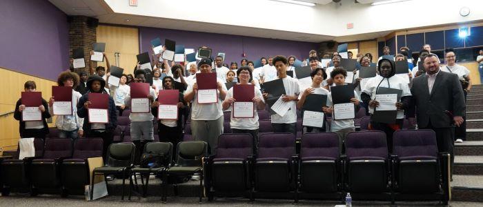 Syracuse City School District students show off their certificates during a P-TECH signing ceremony in OCC's Storer Auditorium.