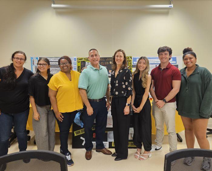 Students in the Criminal Justice Club welcomed Esteban Gonzalez (center left) and Julie Corn (center right) of Onondaga County's 911 Center to campus for their first meeting of the year.
