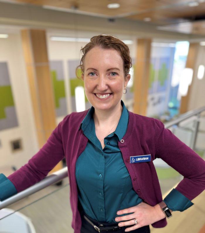 OCC Professor and Librarian Michelle Malinovsky is a member of the inaugural class of SUNY's AI for the Public Good Fellows. She's pictured in the library in Coulter Hall.