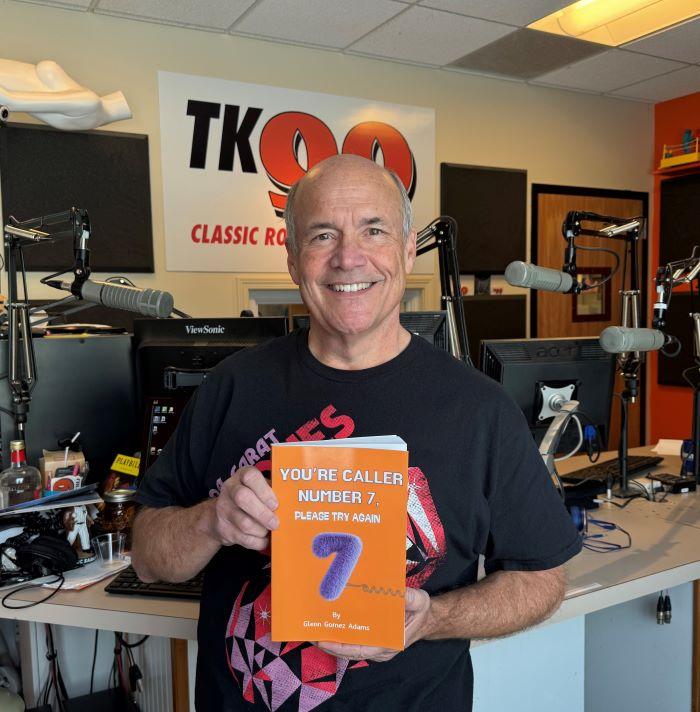 Glenn LaPoint '16 shows off his new book in the studios of radio station TK-99 where he's been a staple of Central new York entertainment for more than 30 years.