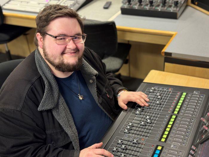 Matt Sage will complete his Sound Recording degree this semester. He's pictured working at an audio board in the Whitney Applied Technology Center.