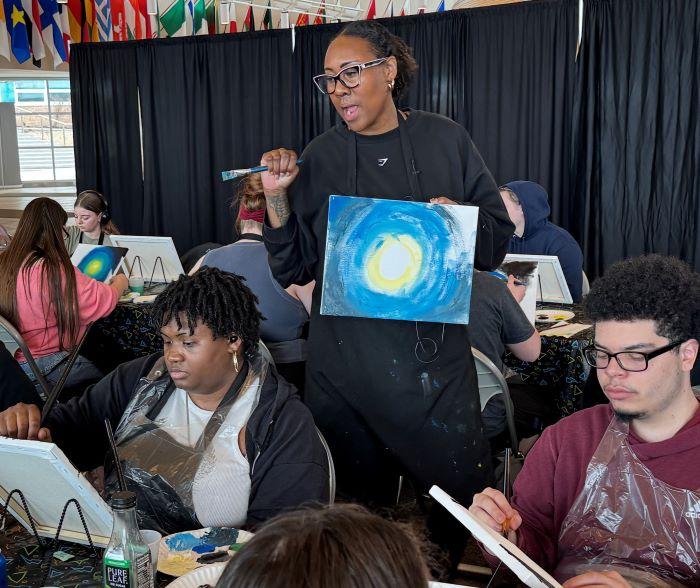 Nikki Hendrix shares her story with students during her painting therapy workshop in the Gordon Student Center.