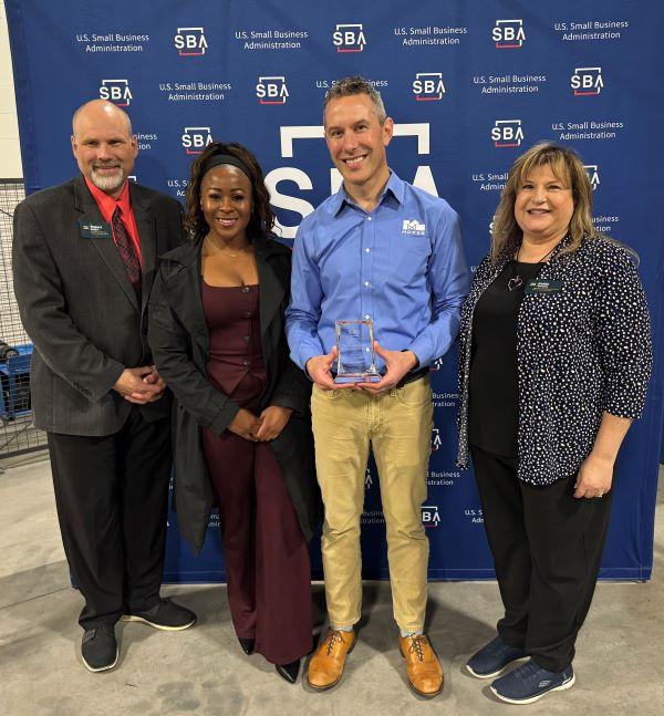 The "Exporter of the Year" Award was presented during National Small Business Week. Pictured (left to right) are Bob Griffin, Sonya Smith, Nate Andrews of Morse Manufacturing, and Kellie Greene.