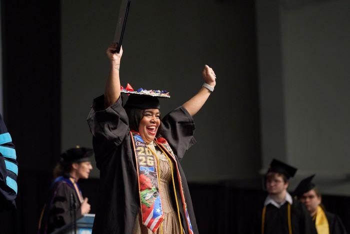 Students celebrated reaching the finish line as they crossed the stage in the SRC Arena during Onondaga Community College's commencement ceremony.