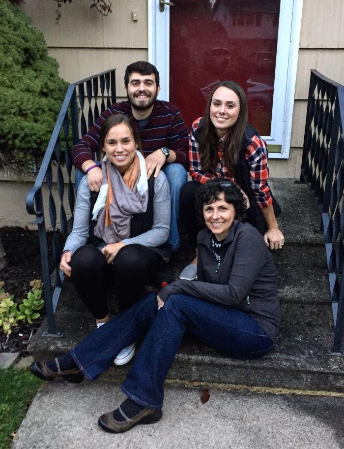 Dee DiCocco (seated on bottom step) is pictured with her three children who all earned Onondaga Community College degrees - Carly (seated next to her), Jeff, and Maria (next to Jeff).
