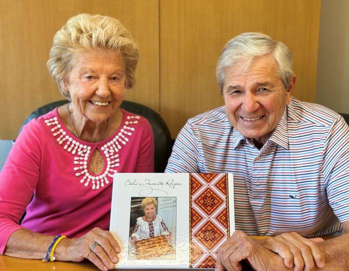 Alumna Halyna Lisnyczyk '65 (left) and her husband and Professor Emeritus Victor Lisnyczyk (right) are pictured with their cookbook, which has raised more than $45,000 for an orphanage in Ukraine.